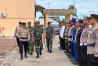 Kodim 1710/Mimika beserta Kepolisian Resort Mimika menggelar apel kesiapan pasukan pengamanan dengan nama 