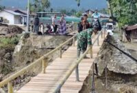 Personel Babinsa Kodim 0113/Gayo Lues, Kodam Iskandar Muda, bersama warga setempat bahu-membahu membangun jembatan darurat