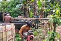 Personel TMMD ke-127 Kodim 1514/Morotai melaksanakan pemasangan mesin bor air dalam rangka pengerjaan sasaran sumur bor di Desa Falila