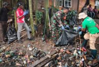 Pelda Wawan Setiawan, anggota Koramil 1710-02/Timika, bersama warga melaksanakan gotong royong